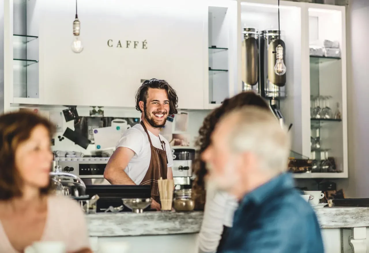 Barista in cafe smiling